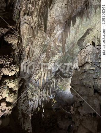Natural cave with stalactites. Grunge karst texture background Natural cave with stalactites. Grunge karst texture background 139508541