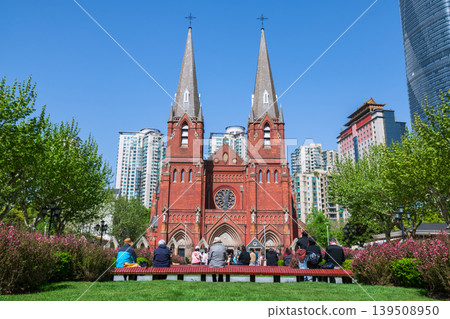 Christian people at garden view St. Ignatius Xujiahui Cathedral, Shianghai Christian people at garden view St. Ignatius Xujiahui Cathedral, Shianghai 139508950