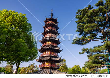 Longhua temple pagoda as flak cannon tower against blue sky, Shanghai Longhua temple pagoda as flak cannon tower against blue sky, Shanghai 139508961