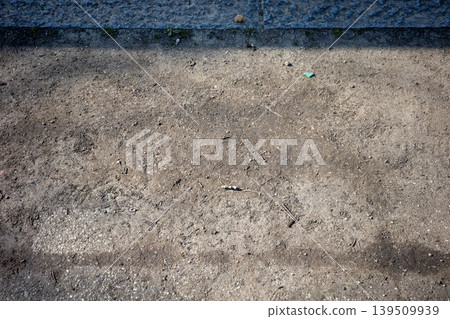 The texture of the gravel ground spreading at the base of the stone wall The texture of the gravel ground spreading at the base of the stone wall 139509939