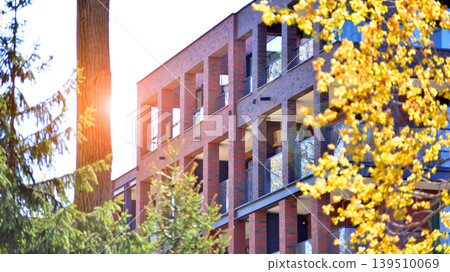 European residential architecture harmonizing with nature. Eco-friendly living in city with greens. Eco apartment building saving energy and fresh air concept.  139510069
