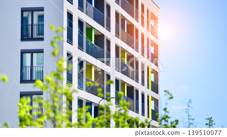 European residential architecture harmonizing with nature. Eco-friendly living in city with greens. Eco apartment building saving energy and fresh air concept. European residential architecture harmonizing with nature. Eco-friendly living in city with greens. Eco apartment building saving energy and fresh air concept. 139510077