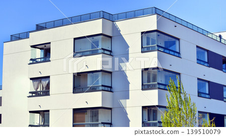European residential architecture harmonizing with nature. Eco-friendly living in city with greens. Eco apartment building saving energy and fresh air concept. European residential architecture harmonizing with nature. Eco-friendly living in city with greens. Eco apartment building saving energy and fresh air concept. 139510079