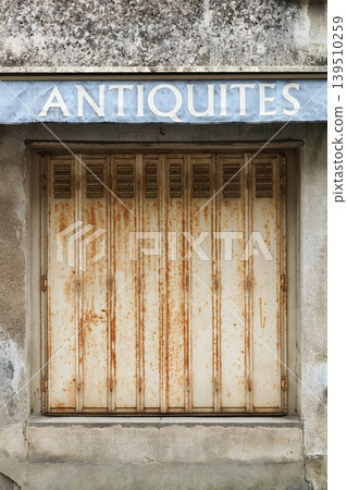Antiques on a wall called antiquites in French language Antiques on a wall called antiquites in French language 139510259