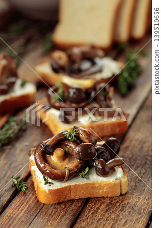 Sandwiches with baked mushrooms on an old wooden table. Sandwiches with baked mushrooms on an old wooden table. 139510656