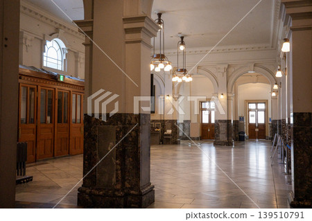 The magnificent passageway of the public hall, with its arches, columns, and chandeliers. The magnificent passageway of the public hall, with its arches, columns, and chandeliers. 139510791