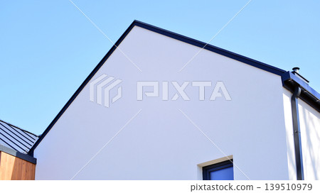 Terraced family homes in newly developed housing estate. The real estate market in the suburbs. New single family houses in a new development area. Residential homes with modern facade.  139510979