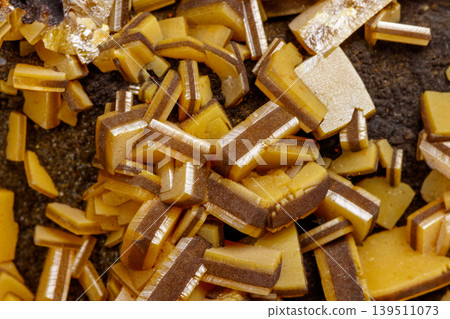 Macro mineral stone yellow Wulfenite on a white background Macro mineral stone yellow Wulfenite on a white background 139511073
