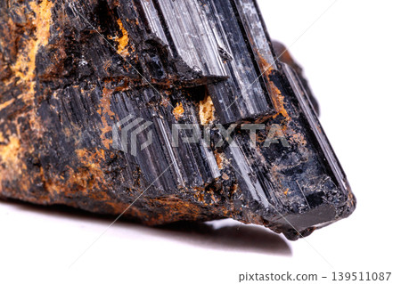 macro mineral stone sherle, schorl, black tourmaline on white background macro mineral stone sherle, schorl, black tourmaline on white background 139511087
