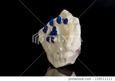 Macro mineral stone Azurite in siltstone against black background Macro mineral stone Azurite in siltstone against black background 139511111