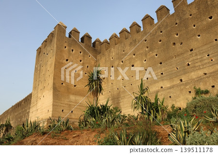 Ancient stone fortress stands tall against clear blue sky Ancient stone fortress stands tall against clear blue sky 139511178