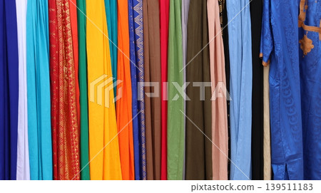 Vibrant textiles hang neatly in a colorful row Vibrant textiles hang neatly in a colorful row 139511183