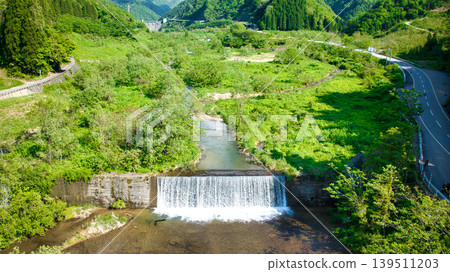 In May, snowmelt water flows through a small stream in eastern Toyama Prefecture. In May, snowmelt water flows through a small stream in eastern Toyama Prefecture. 139511203