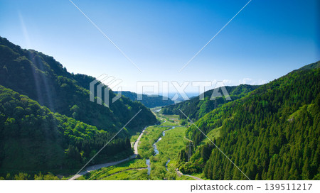 In May, snowmelt water flows through a small stream in eastern Toyama Prefecture. 139511217