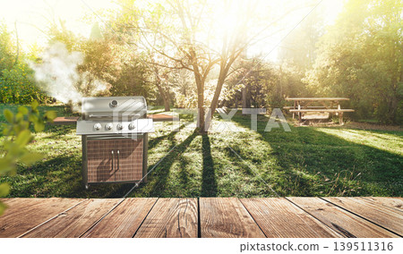 summer time in backyard garden with grill BBQ, wooden table, blurred background 139511316