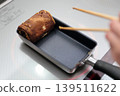 Cook an omelet and burn it. 139511622