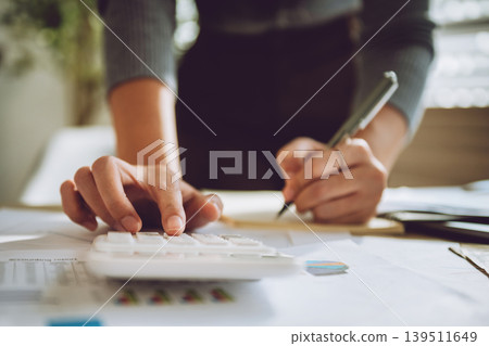 Hands calculate figures with calculator and pen Hands calculate figures with calculator and pen 139511649