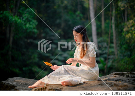 beautiful woman in white dress in deep forest, elf princess fairy tale concept beautiful woman in white dress in deep forest, elf princess fairy tale concept 139511871