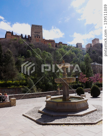 Fountain at the Paseo de los Tristes (Park of the Sad People) with the Alhambra castle in the background 139511889