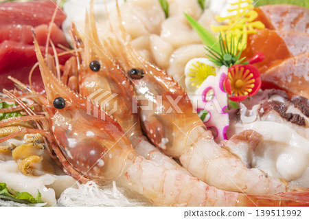 A luxurious sushi platter featuring fresh shrimp and scallops. A luxurious sushi platter featuring fresh shrimp and scallops. 139511992