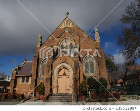 The majestic church facade, with its spires and arches, creates a weighty landscape woven from brick and stone decorations. The majestic church facade, with its spires and arches, creates a weighty landscape woven from brick and stone decorations. 139512994