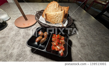 Appetizer toast with fresh tomato salsa and olives 139513001