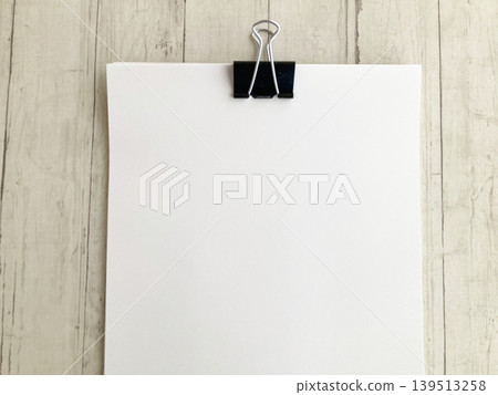 List creation, announcements, administrative tasks, household budget management, and white papers clipped together on a wooden table. 139513258