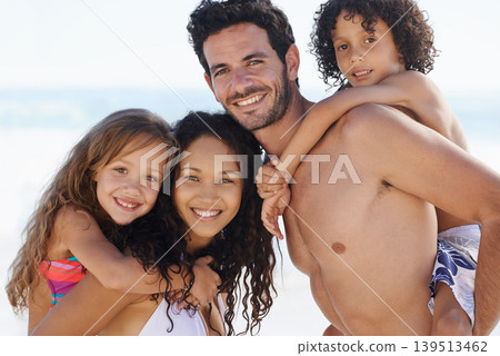 Happy family, portrait and hug for bonding, vacation or outdoor holiday weekend together. Father, mother and children smile for piggyback, love or back ride on summer break by ocean coast in nature Happy family, portrait and hug for bonding, vacation or outdoor holiday weekend together. Father, mother and children smile for piggyback, love or back ride on summer break by ocean coast in nature 139513462