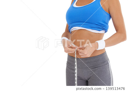 Woman, stomach and measure tape for diet, weight loss and health results or fitness progress in studio. Model hands check body or abdomen for exercise goals, training or workout on a white background Woman, stomach and measure tape for diet, weight loss and health results or fitness progress in studio. Model hands check body or abdomen for exercise goals, training or workout on a white background 139513476