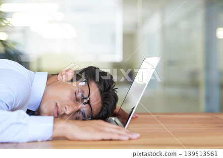 Business man, laptop and sleeping at desk, exhausted and burnout in office or dreaming in workplace. Male professional, nap and overtime or overworked, stress and fatigue or tired and deadline Business man, laptop and sleeping at desk, exhausted and burnout in office or dreaming in workplace. Male professional, nap and overtime or overworked, stress and fatigue or tired and deadline 139513561