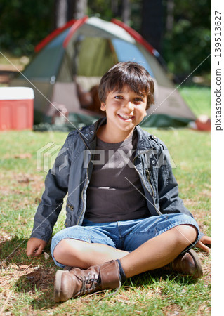 Relax, camping or portrait of happy kid in nature for playing, adventure or holiday vacation in park. Grass, confidence or male child with smile in woods, garden or forest for fun hiking or childhood 139513627