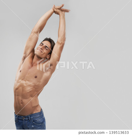 Man, stretching and fitness pride in studio, relaxing and smiling by gray background. Male person, wellness and confidence for healthy body, muscle development and results or progress by mockup space Man, stretching and fitness pride in studio, relaxing and smiling by gray background. Male person, wellness and confidence for healthy body, muscle development and results or progress by mockup space 139513633