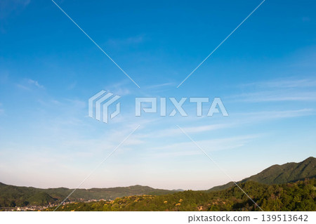 A landscape of early summer mountains and wispy clouds. A landscape of early summer mountains and wispy clouds. 139513642