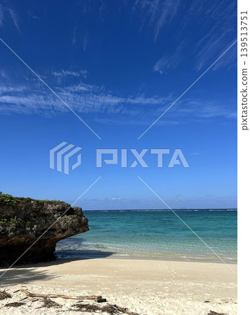 Okinawa's clear waters showcase its white sandy beaches and rocky reefs. 139513751