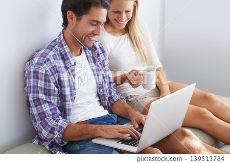 Couple, happy and laptop on sofa in home for movie, social media or web streaming with bonding and love. Technology, man or woman with computer pc or coffee for internet scroll and tv show with care 139513784