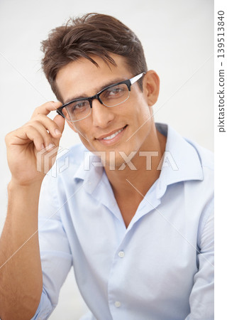 Happy man, face and glasses choice for vision with eye care, optometry and professional style on white background. Smile in portrait for eyesight with fashion frame and prescription lens in studio Happy man, face and glasses choice for vision with eye care, optometry and professional style on white background. Smile in portrait for eyesight with fashion frame and prescription lens in studio 139513840