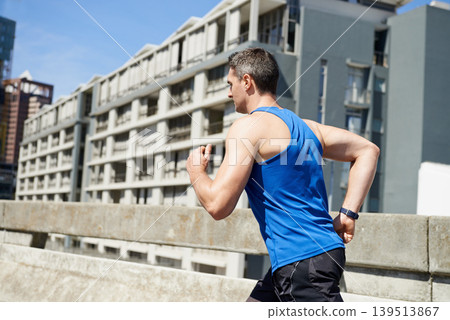 Man, fitness and running on road in city for workout, exercise or outdoor cardio with buildings. Active male person, athlete or runner in training or practice for health and wellness in an urban town 139513867