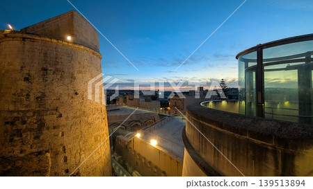 View of the city from the fort at dusk in Gozo View of the city from the fort at dusk in Gozo 139513894