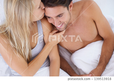 Above, bedroom or happy couple kiss on vacation or romantic honeymoon holiday to celebrate marriage. Morning, love or people hug to cuddle in home, house or hotel together with romance, bond or care Above, bedroom or happy couple kiss on vacation or romantic honeymoon holiday to celebrate marriage. Morning, love or people hug to cuddle in home, house or hotel together with romance, bond or care 139513918