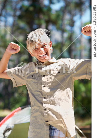 Child, portrait or arms raised in nature for success, winning or goal on holiday vacation in woods. Forest, summer or excited male kid with smile for victory, freedom or camping in woods or park 139513995