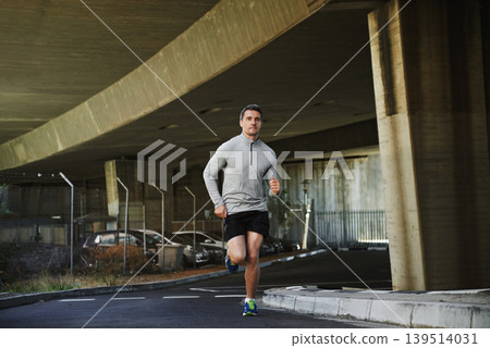Man, runner and exercise on street in outdoors, cardio and fitness or training for marathon. Male person, athlete and workout by city background, sportswear and performance challenge by bridge Man, runner and exercise on street in outdoors, cardio and fitness or training for marathon. Male person, athlete and workout by city background, sportswear and performance challenge by bridge 139514031