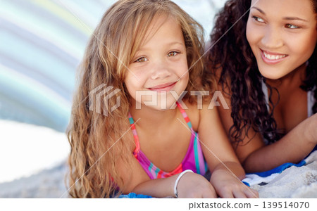 Happy girl, portrait and relax on beach with mother for fun day outside by the ocean coast in nature. Face of little female person, child or kid smile lying on sand by sea with mom for family bonding Happy girl, portrait and relax on beach with mother for fun day outside by the ocean coast in nature. Face of little female person, child or kid smile lying on sand by sea with mom for family bonding 139514070