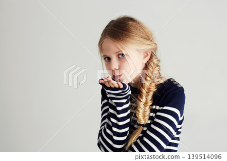 Fashion, kiss and portrait of child in a studio with casual, cool and stylish outfit and hat. Happy, youth and young girl kid with positive, good and confident attitude for style by white background Fashion, kiss and portrait of child in a studio with casual, cool and stylish outfit and hat. Happy, youth and young girl kid with positive, good and confident attitude for style by white background 139514096