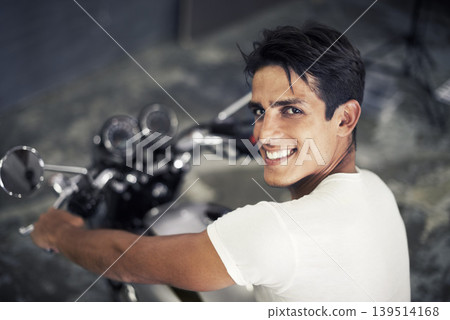 Happy man, portrait and motorcycle vehicle in garage for travel, transportation or road trip adventure. Face of young handsome male person or biker smile on cool automobile or mechanical motorbike Happy man, portrait and motorcycle vehicle in garage for travel, transportation or road trip adventure. Face of young handsome male person or biker smile on cool automobile or mechanical motorbike 139514168