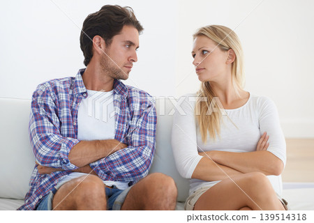 Couple, angry and living room couch with disagreement, upset and staring with anger, fight or mad. Divorce, betrayal and relationship with cheating, stress and argument for marriage, home or toxic Couple, angry and living room couch with disagreement, upset and staring with anger, fight or mad. Divorce, betrayal and relationship with cheating, stress and argument for marriage, home or toxic 139514318