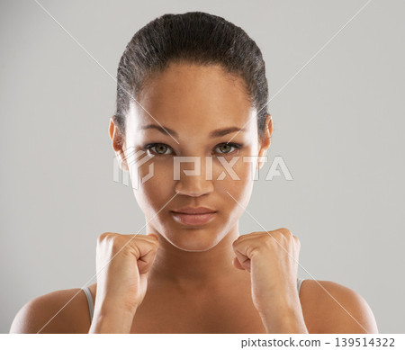 Woman, portrait and fists for fight, self defense or fitness against a gray studio background. Face of female person or fighter with hands in martial arts for strength, power or protection on mockup Woman, portrait and fists for fight, self defense or fitness against a gray studio background. Face of female person or fighter with hands in martial arts for strength, power or protection on mockup 139514322