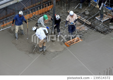 Image of the concrete pouring process for the slab. Image of the concrete pouring process for the slab. 139514372
