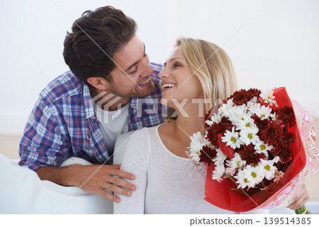 Man, flowers and surprise in home, happy woman and hug boyfriend for anniversary celebration. Birthday gift, romance and bouquet for love, present and valentines day with romantic gesture and smile Man, flowers and surprise in home, happy woman and hug boyfriend for anniversary celebration. Birthday gift, romance and bouquet for love, present and valentines day with romantic gesture and smile 139514385