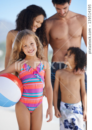 Happy child, portrait and ball on beach with family for fun summer, weekend or outdoor holiday together. Little girl smile with mother, father and sibling for vacation on ocean coast or sea in nature Happy child, portrait and ball on beach with family for fun summer, weekend or outdoor holiday together. Little girl smile with mother, father and sibling for vacation on ocean coast or sea in nature 139514395