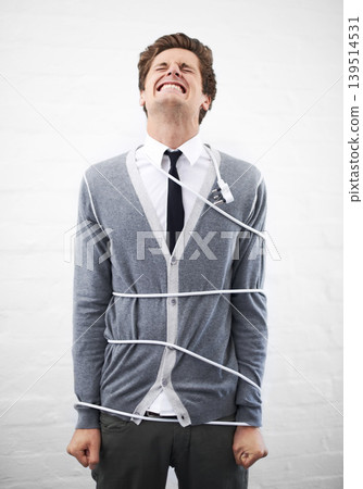 Man, electrician and tied with cord, boss and portrait for employee, work, angry or job. Frustrated, employer and furious on white background, problem or failure with bad news, stress or risk 139514531